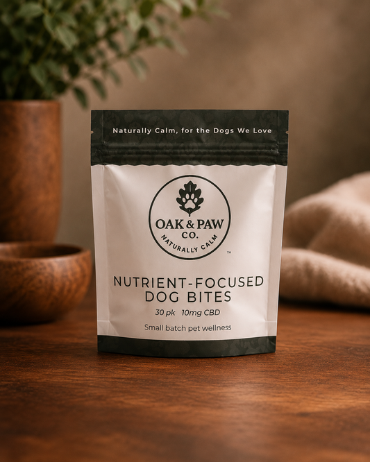 Package of Oak & Paw Co. nutrient-focused dog bites on a wooden surface with a blurred background